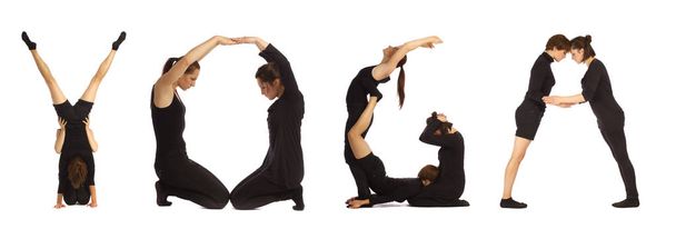 Black dressed people forming YOGA word over white - Foto, immagini
