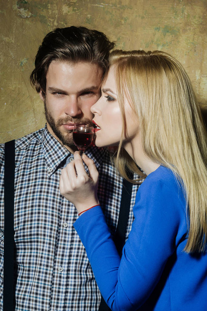 Girlfriend and boyfriend posing with glass of red liqueur - 写真・画像