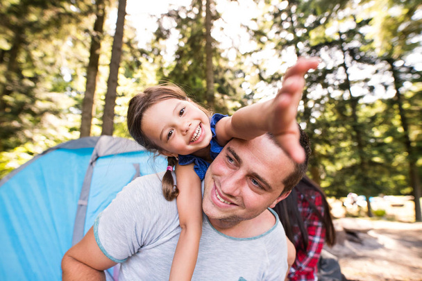 Young father with cute little daughter camping in forest. - Foto, imagen