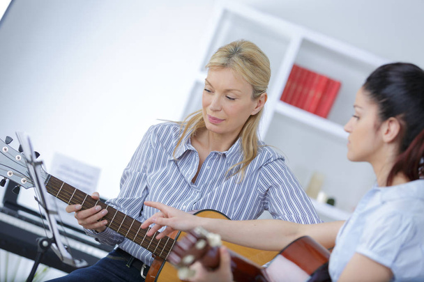 guitar teacher teaching a girl - Zdjęcie, obraz