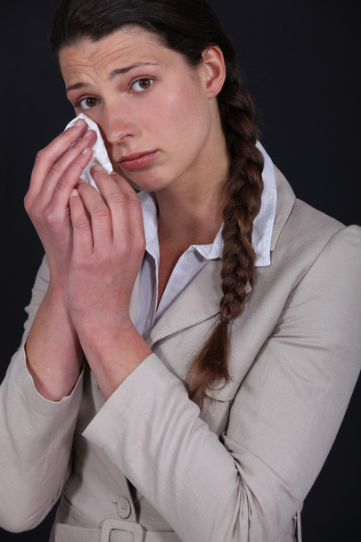 Young woman shedding tears - 写真・画像