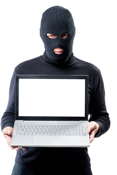 Hacker in a mask with a laptop, space for writing on the laptop' - Foto, imagen