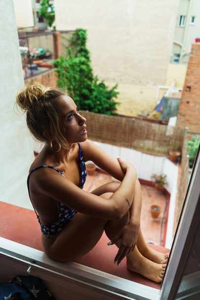 Sensual woman in swimming suit in window - Foto, Bild