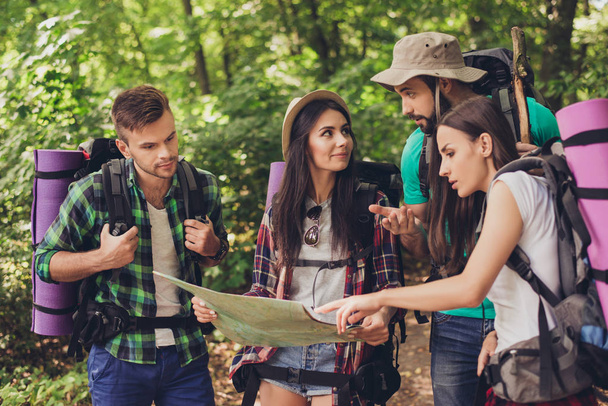 Four tourists got lost in the forest, holding map, trying to fin - Foto, Imagem