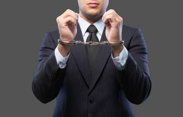 Man in handcuffs behind his back - Фото, зображення