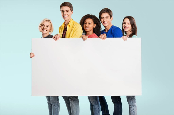 Teens holding blank banner - Фото, изображение