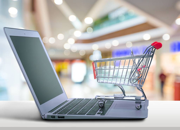 Laptop and shopping cart - Photo, Image