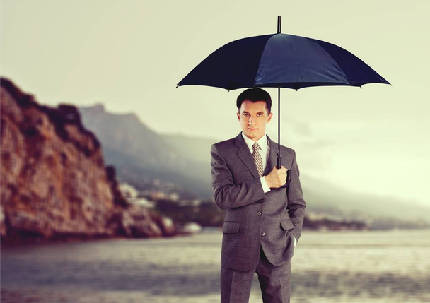 business man with umbrella - Фото, зображення