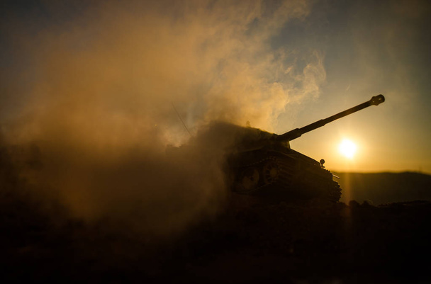 War Concept. Military silhouettes fighting scene on war fog sky background, World War Soldiers Silhouettes Below Cloudy Skyline At sunset. Attack scene. German tank in action - Photo, Image