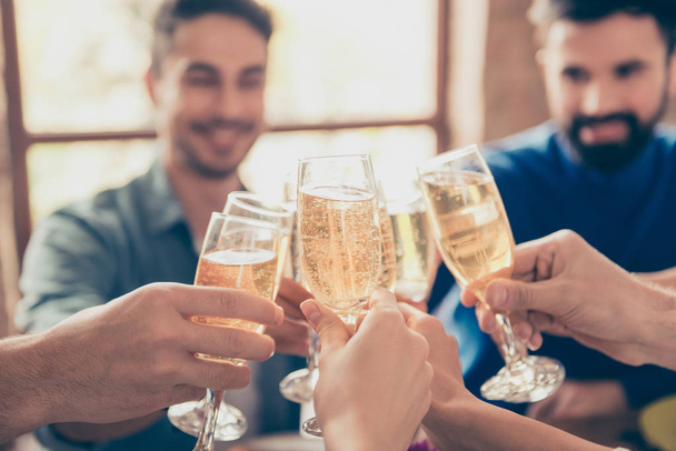 Close up of friends cliking the glasses of bubbling champaigne t - Valokuva, kuva