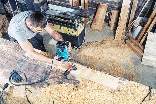 man saws a wooden board  - Photo, Image