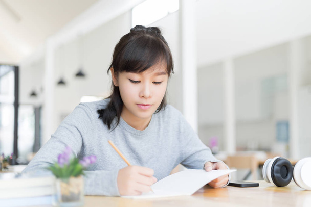 university student thinking and writing in the notebook, education and learning concept - Photo, Image