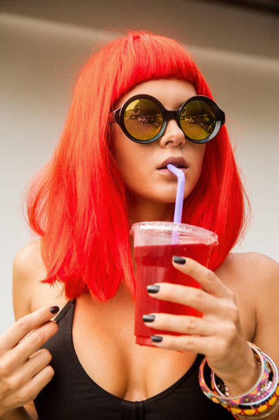 Woman with red hairs drink red cocktail. - Φωτογραφία, εικόνα
