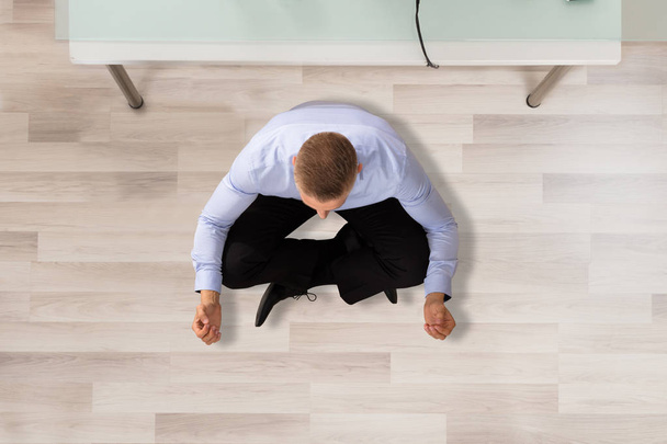 Businessman Doing Meditation In Office - Фото, изображение