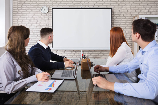 Group Of Business People Looking At White Board In Business Meeting - Foto, Imagem