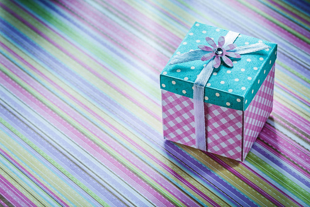 Wrapped present box on stripy fabric background celebrations con - Foto, Imagem