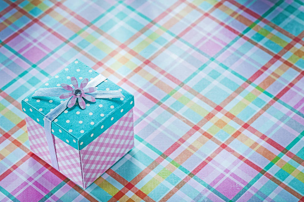 Wrapped gift box on checked fabric background holidays concept - Fotó, kép