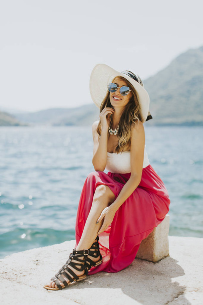 Joven mujer atractiva posa junto al mar
 - Foto, Imagen