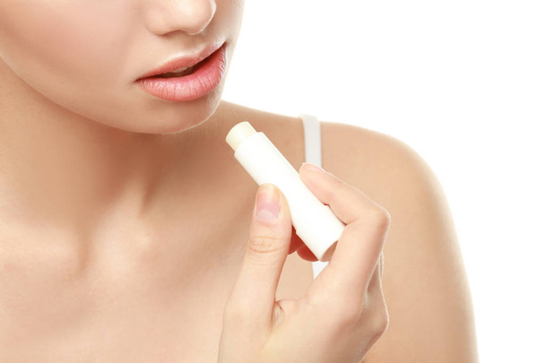 Closeup view of beautiful young woman applying lipstick - Fotografie, Obrázek