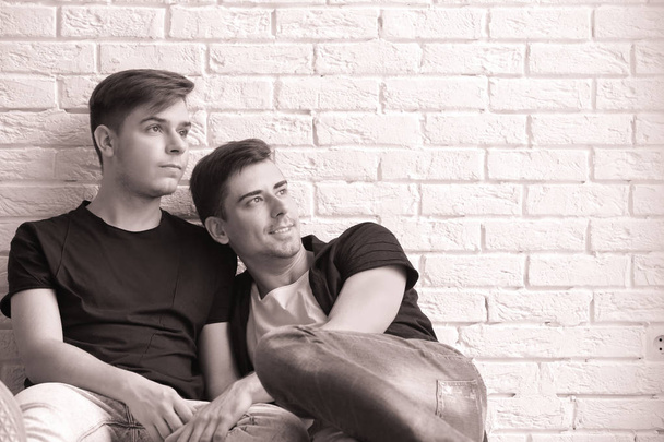 Gay couple on brick wall - Foto, Imagem