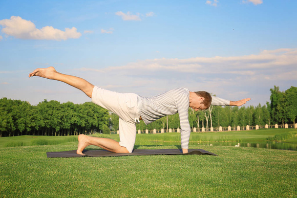 Young man practicing yoga - 写真・画像