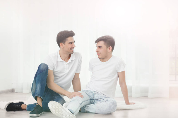 Gay couple sitting on floor  - Photo, image