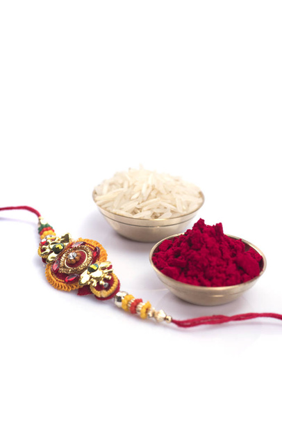 Indian festival: Raksha Bandhan background with an elegant Rakhi. A traditional Indian wrist band which is a symbol of love between Brothers and Sisters - Фото, изображение