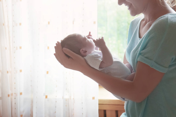 woman holding her newborn baby - Foto, Bild
