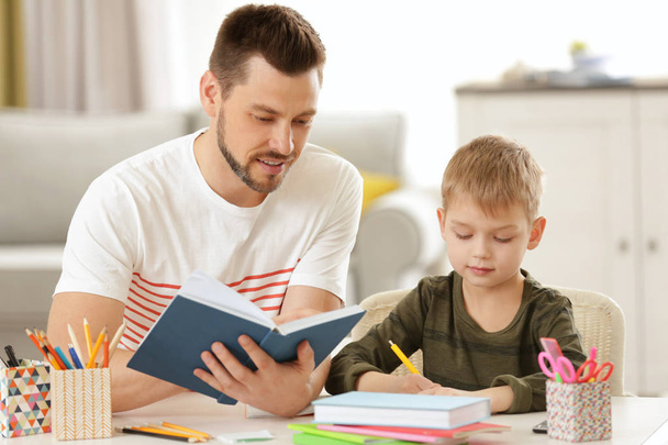 Father and son doing homework - Фото, изображение
