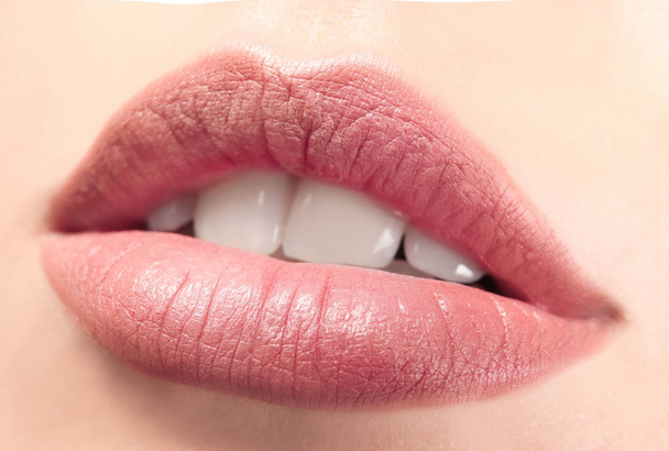 Closeup view of beautiful young woman with natural lips makeup - Photo, image