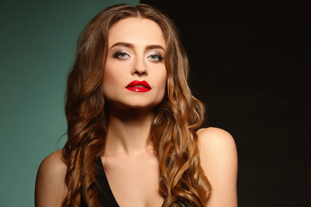 Beautiful young woman with bright lips on color background - Foto, imagen