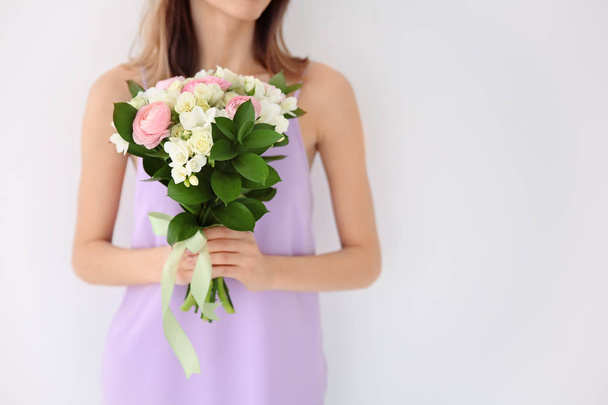 Young woman holding beautiful bouquet  - Foto, Imagen