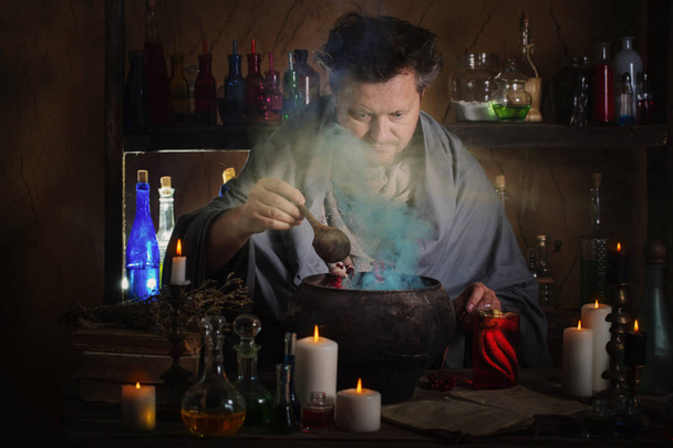 wizard brews a potion - Fotó, kép