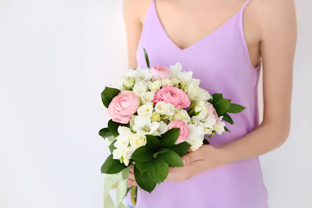 Young woman holding beautiful bouquet  - Fotó, kép