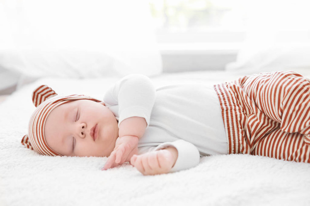 Cute little baby sleeping on plaid at home - Foto, immagini