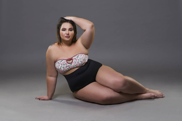 Plus size fashion model in sexy swimsuit, young fat woman on gray background, overweight female body - Foto, Imagem