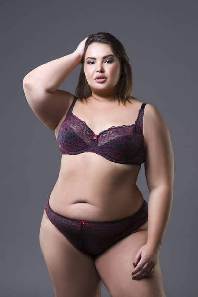 Plus size fashion model in underwear, young fat woman on gray background, overweight female body - Fotografie, Obrázek