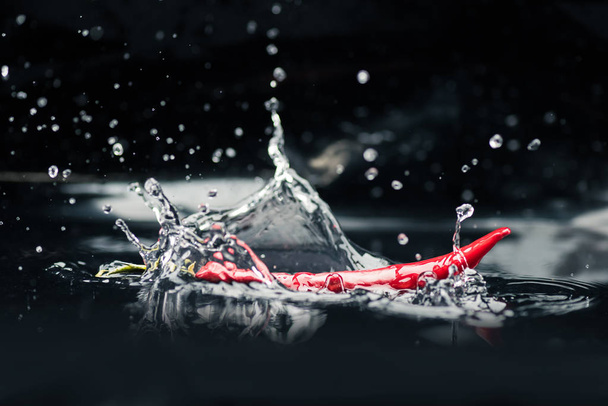 chili pepper falling in water - Photo, Image