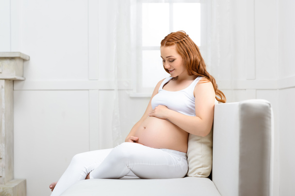 pregnant woman touching her belly - Fotografie, Obrázek