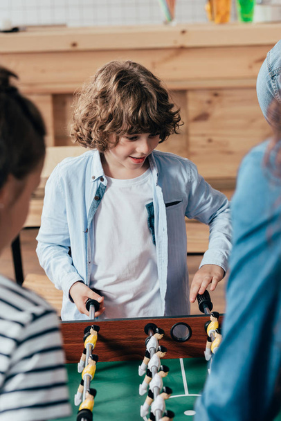 boy playing table football with family - Photo, Image