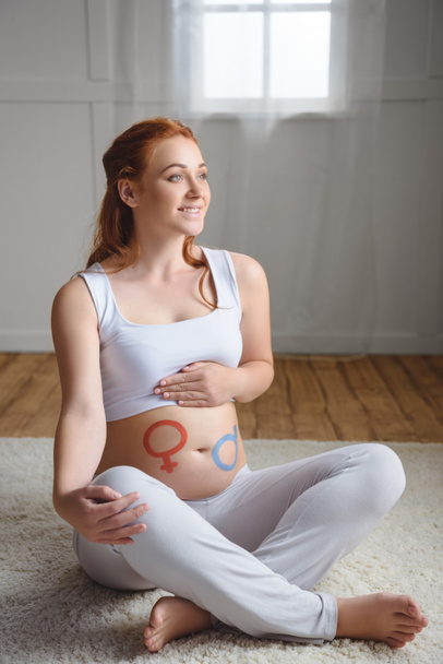 pregnant woman with boy or girl symbols - Фото, зображення