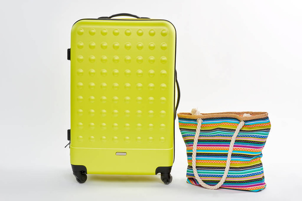 Bright summer suitcase on wheels. - Photo, Image