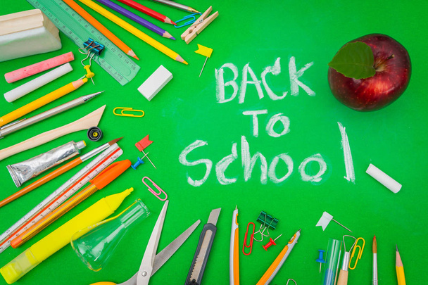 School supplies on Green chalkboard " Back to school background  - Photo, Image