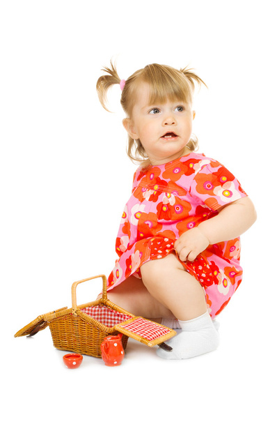 Small baby in red dress with toy basket - Zdjęcie, obraz
