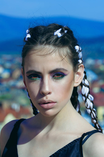 Girl with fashionable makeup on blue sky background. - Фото, изображение
