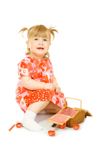 Small smiling baby in red dress with toy - Foto, imagen
