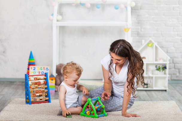 mother and her son play together indoor - Photo, Image