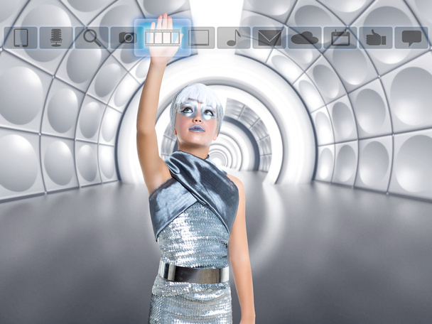 futuristic kid girl in silver touching finger icons - Foto, Imagen