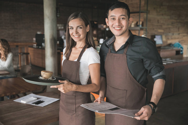 two waitress smiling to camera in the cafe - Valokuva, kuva