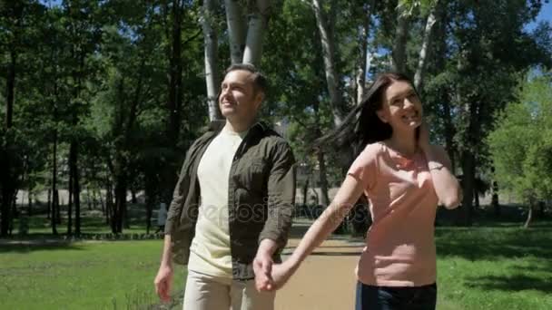 Positive couple spinning in the park - Materiaali, video